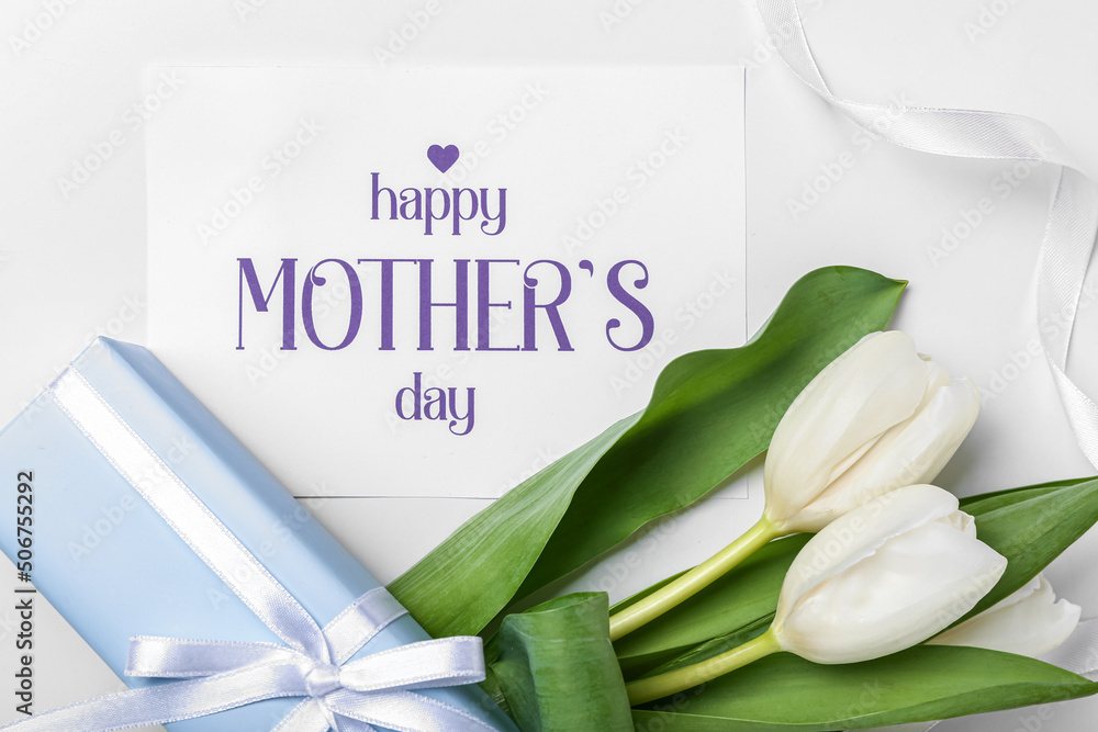 Card with text HAPPY MOTHERS DAY, tulips and gift box on white background