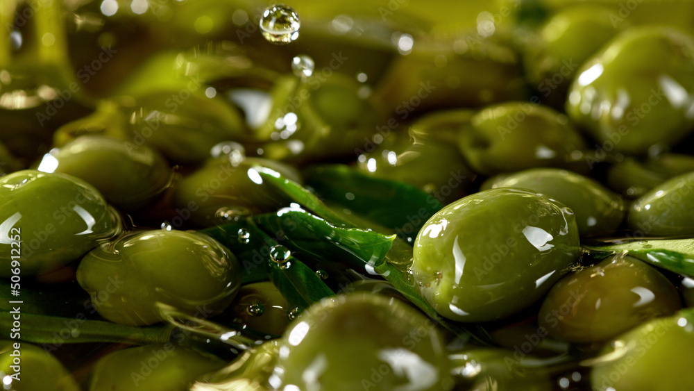 Close-up of green olives placed in oil.