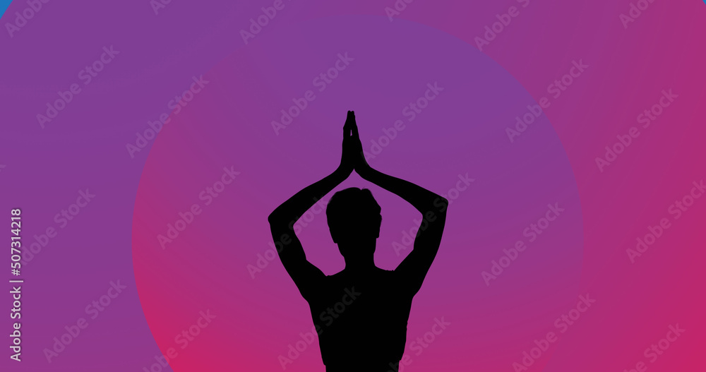 Image of woman meditating silhouette on purple background