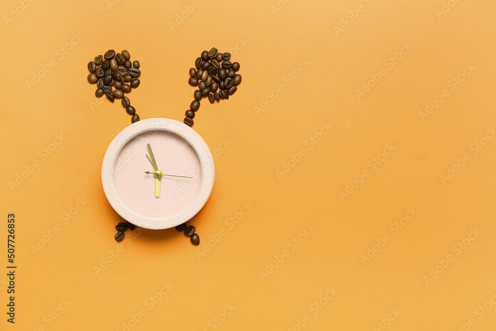 Composition with alarm clock and coffee beans on color background