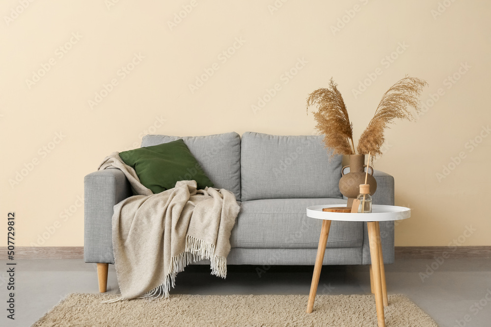 Interior of living room with grey sofa and table