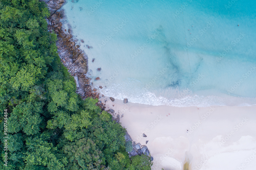 Aerial view Top down seashore wave crashing on seashore Beautiful turquoise sea surface in sunny day