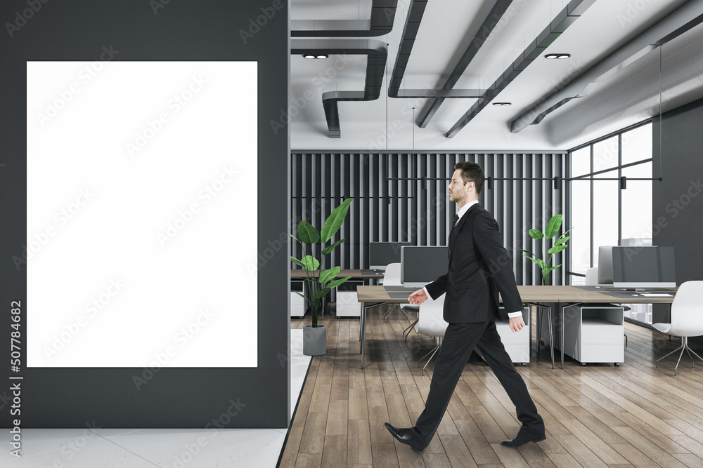 businessperson walking in wooden and concrete office interior with furnituire and window with city v