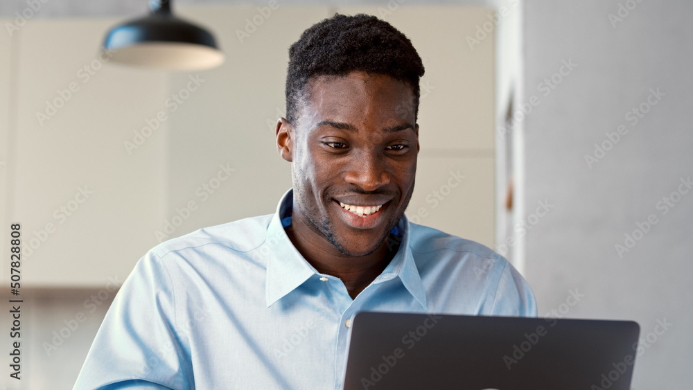 Smiling young student communicating via video call using computer