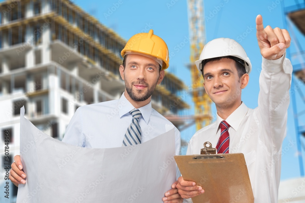 Engineer or architect with building plan at construction site, business, building, industry, people 