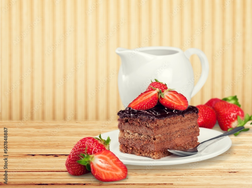 Tasty homemade chocolate cake on the plate on the desk