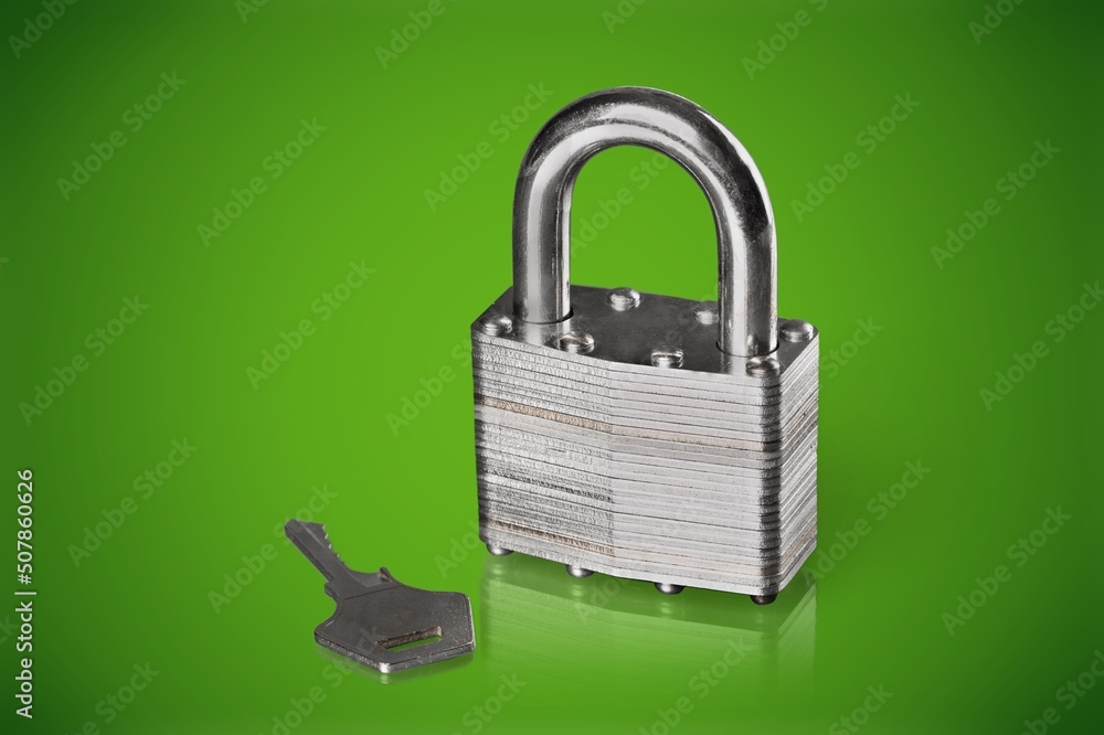 Simple lock and key. Small worn padlock with shiny key. Business data encryption, home security, or 