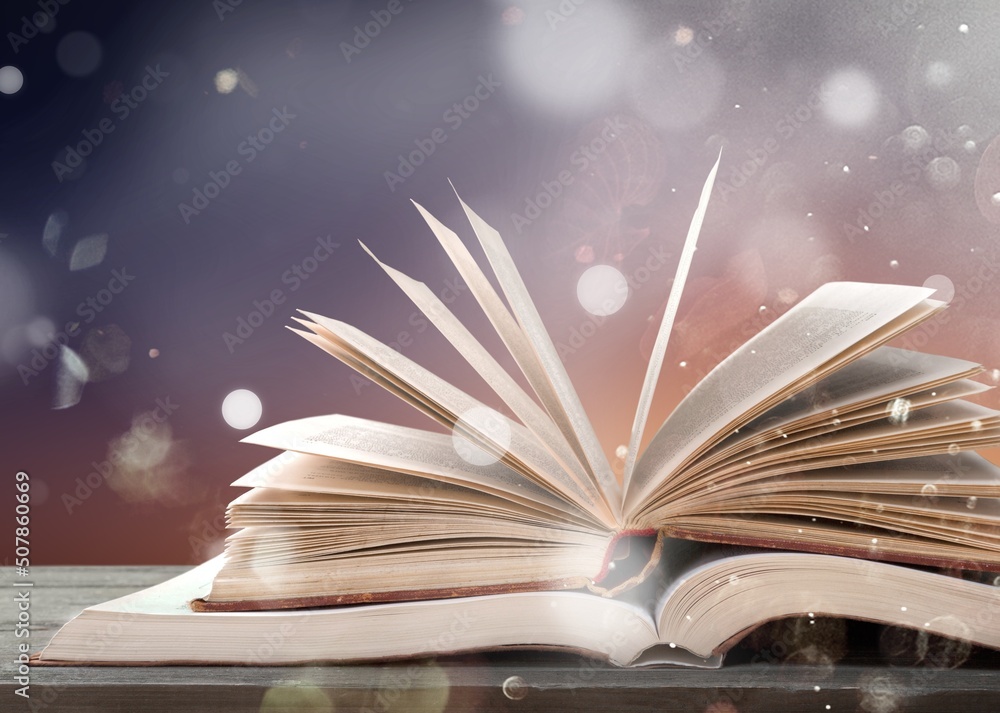 Old book or Holy Bible open on a table background with light