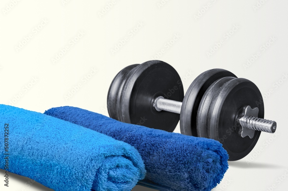 barbell weight and towel at desk. sport gym concept