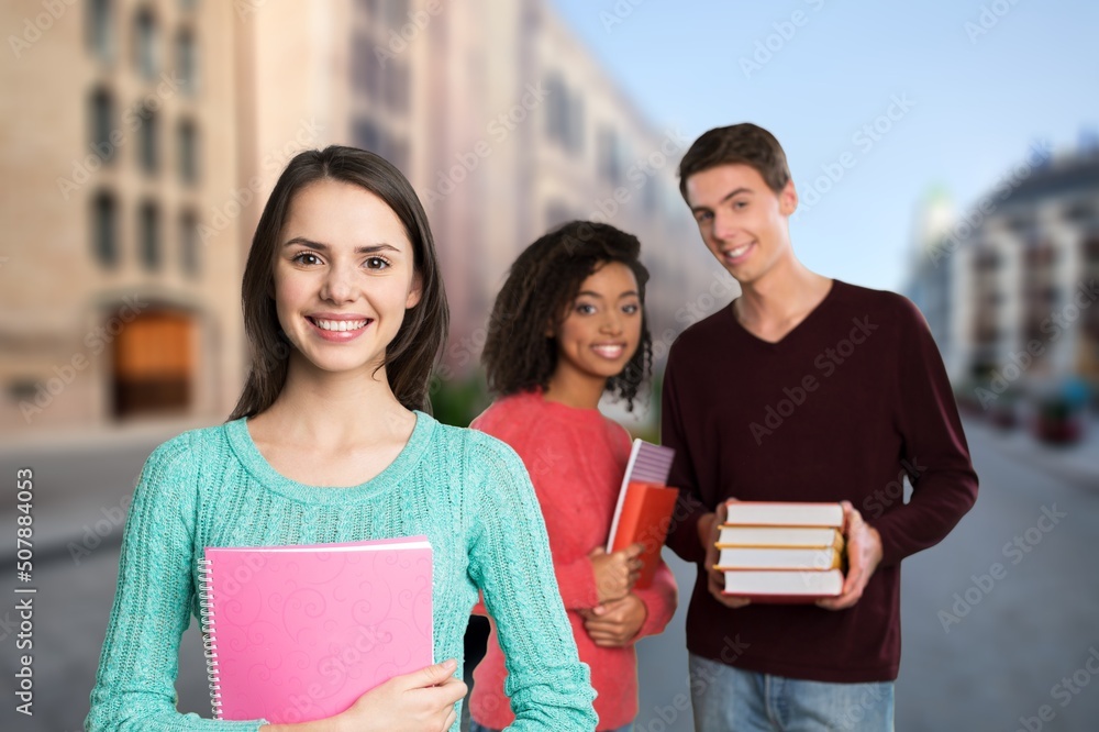 Teenage students spending time together after lessons, talking and having fun outdoors background