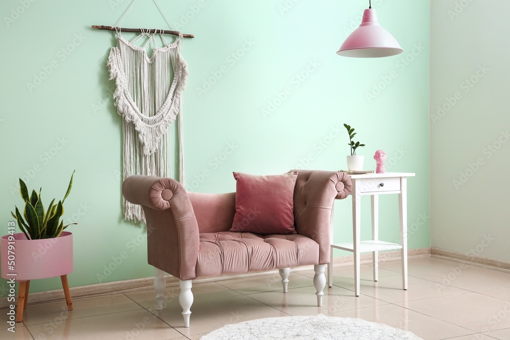 Pink couch and tables near light color wall