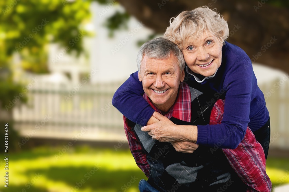 Portrait of happy senior couple smiling at natural background