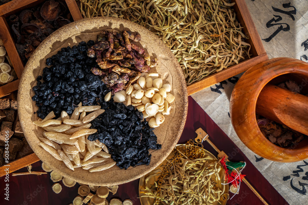 Chinese herbal medicine and flower tea on wooden