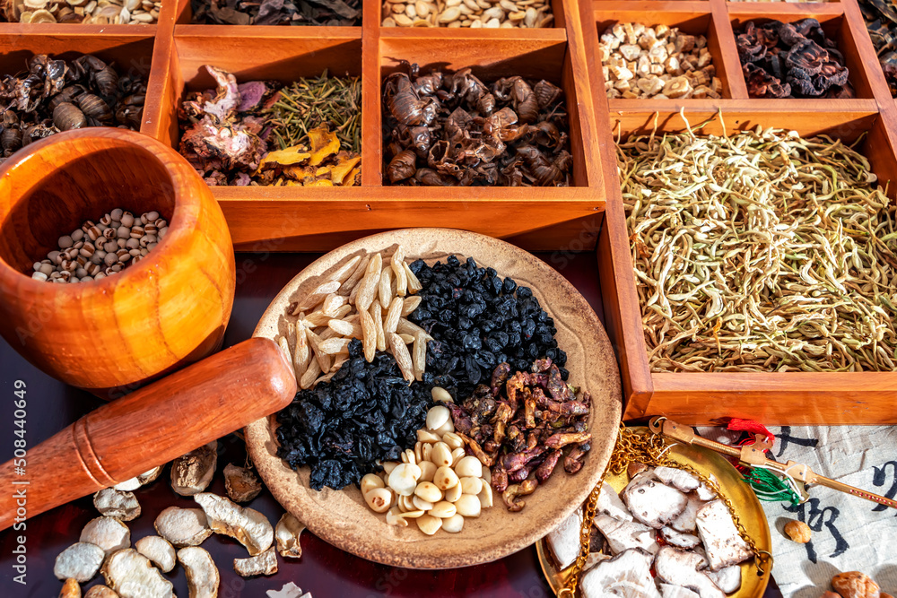 Chinese herbal medicine and flower tea on wooden