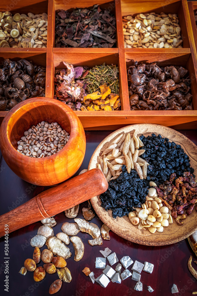 Chinese herbal medicine and flower tea on wooden