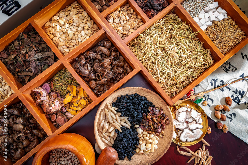 Chinese herbal medicine and flower tea on wooden