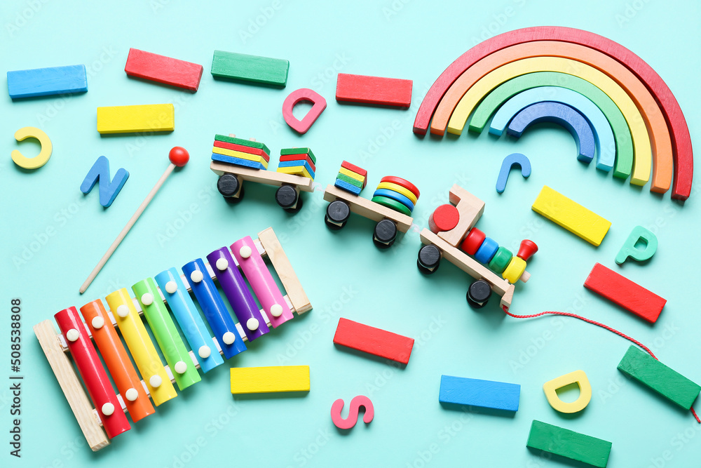 Toy train with building blocks and xylophone on blue background