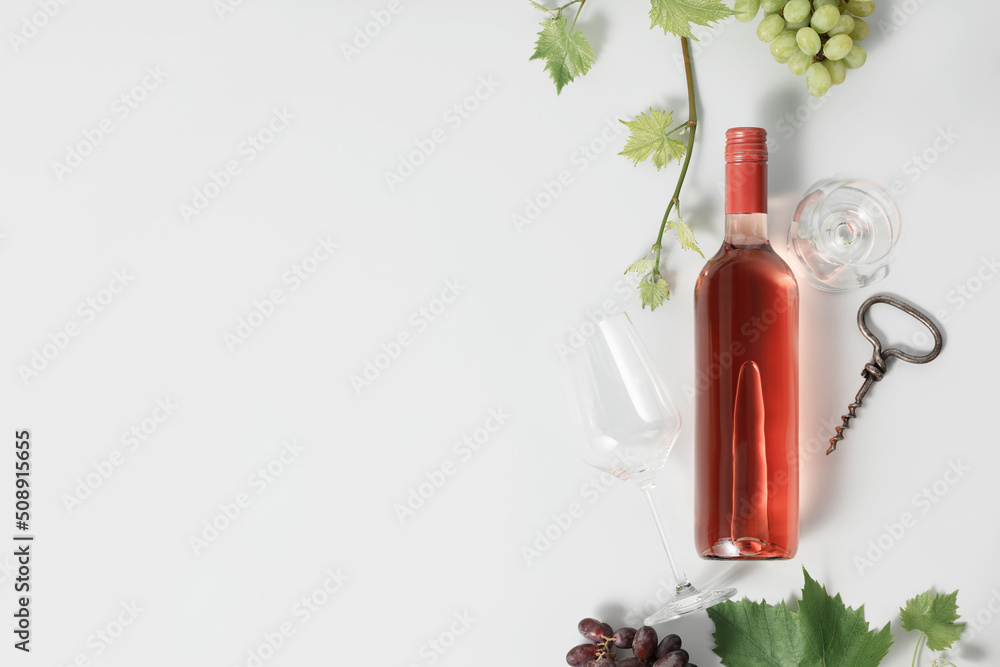 Bottle of Rose wine and grape. Flat-lay of rose wine on white background