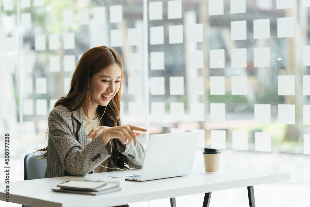 Young beautiful woman using her laptop while sitting in a chair at her working place,  Small busines