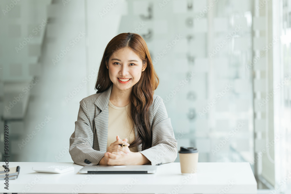 Young beautiful woman using her laptop while sitting in a chair at her working place,  Small busines