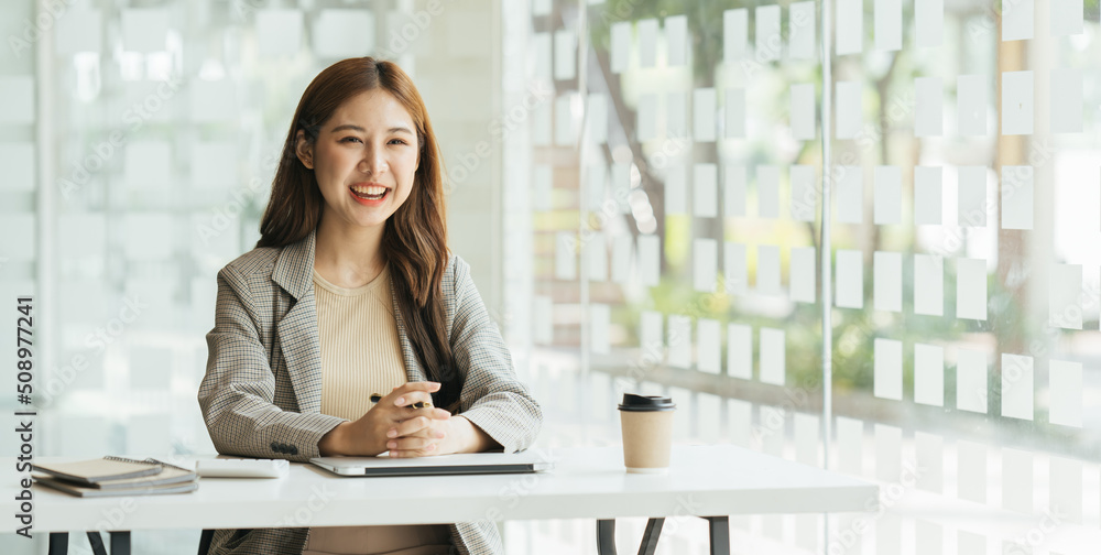 Young beautiful woman using her laptop while sitting in a chair at her working place,  Small busines