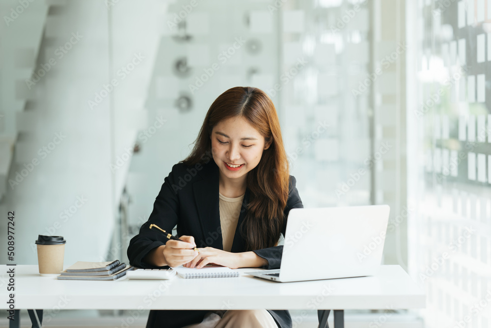 Young beautiful woman using her laptop while sitting in a chair at her working place,  Small busines