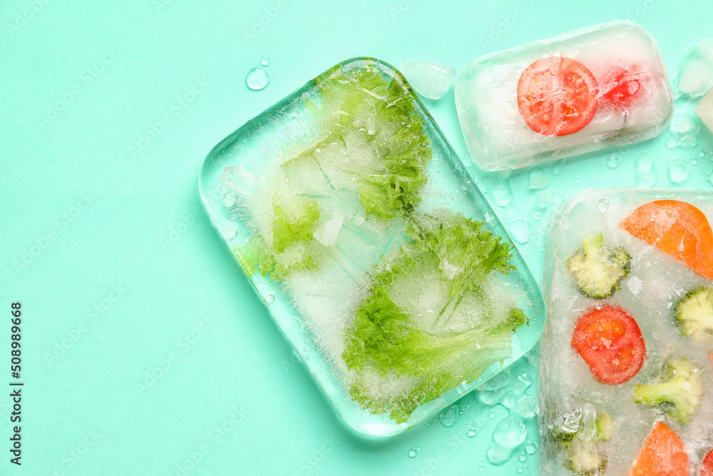 Fresh cut vegetables frozen in ice on turquoise background