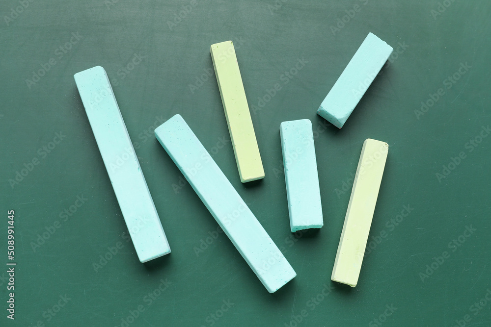 Pieces of chalk on green blackboard