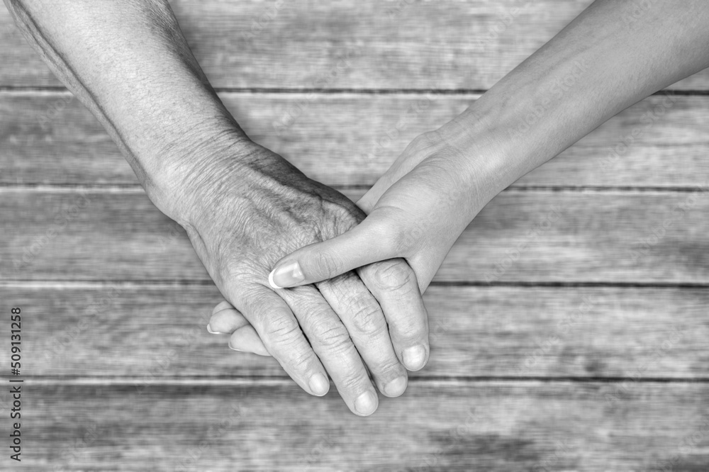 old mans hand and woman;s hand, black and white color