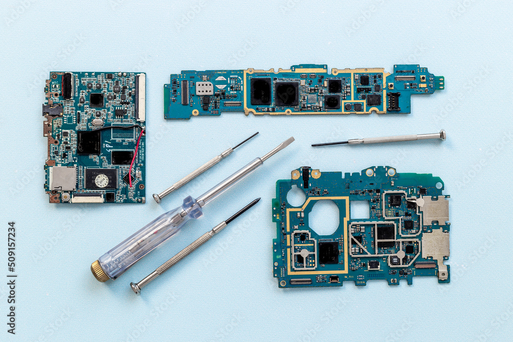 Electronics checkup - circuit board with microchips and tools, top view