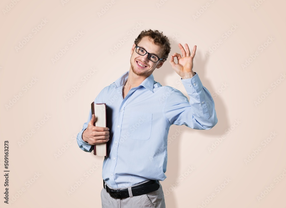 Happy successful business man posing on background