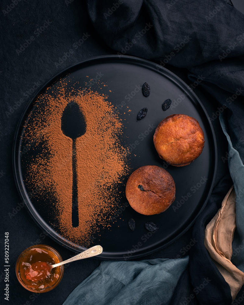 Muffins with raisin on black plate served decorated for restaurant.Close up.Top view.