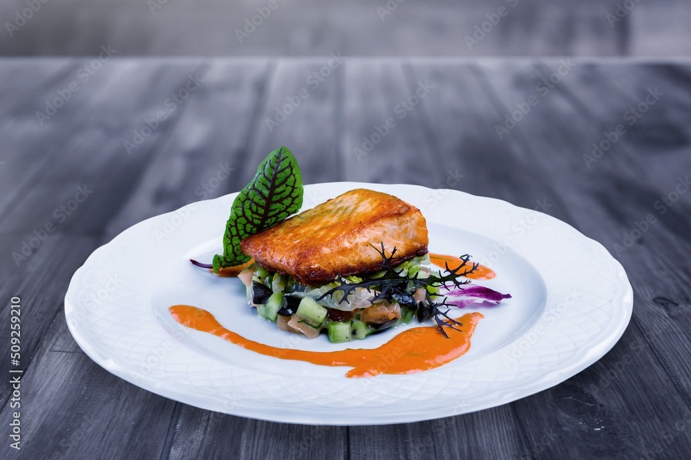 fried fish fillets on a plate on a wooden table