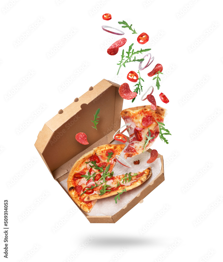 Freshly baked spicy pizza with ingredients in the air isolated on a white background