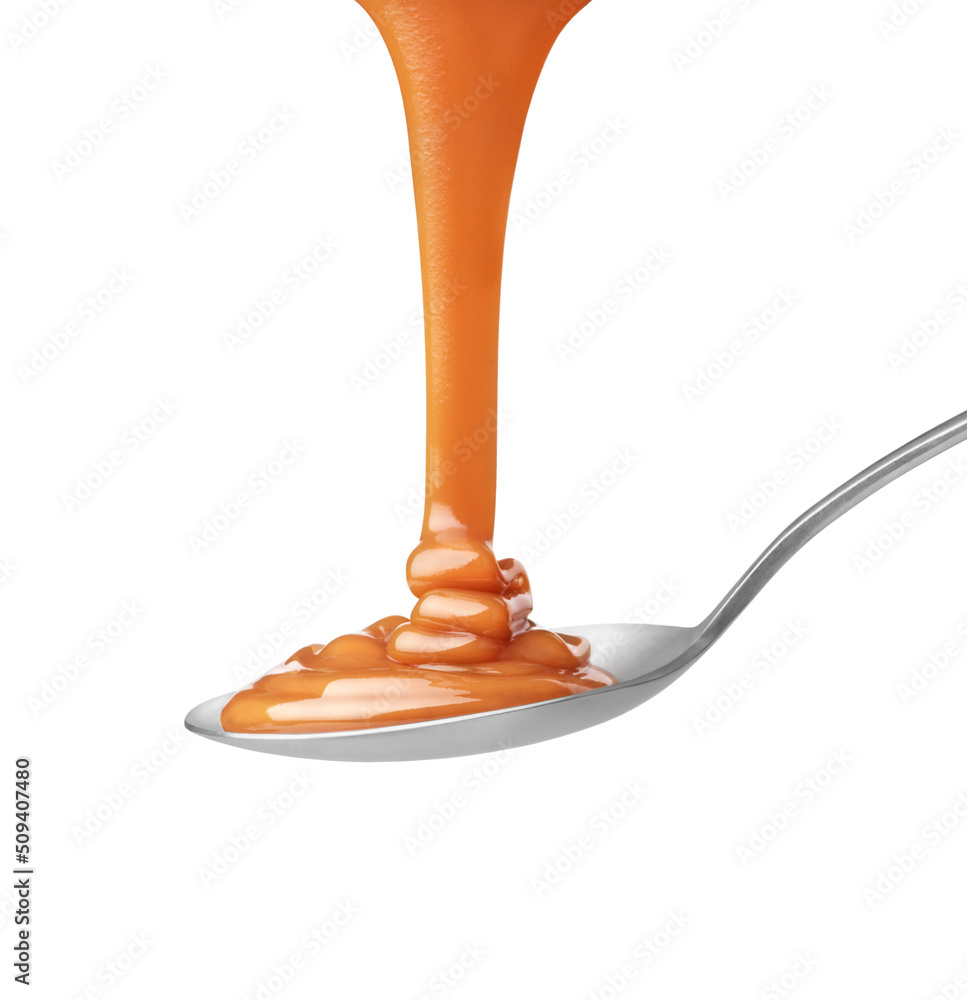 drip of caramel in a spoon on a white background