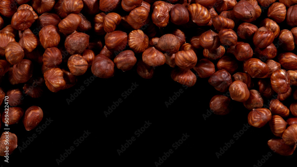 Hazelnuts isolated on black background.