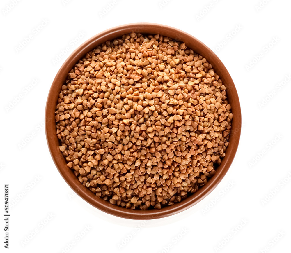 Bowl with buckwheat grains on white background