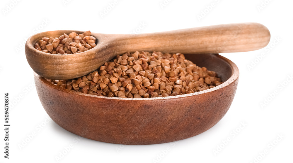 Wooden bowl with buckwheat grains and spoon on white background