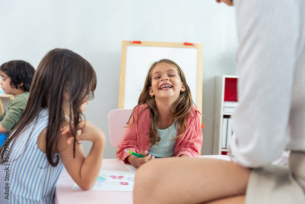 Caucasian beautiful woman teacher teach fun activity to kids at school	