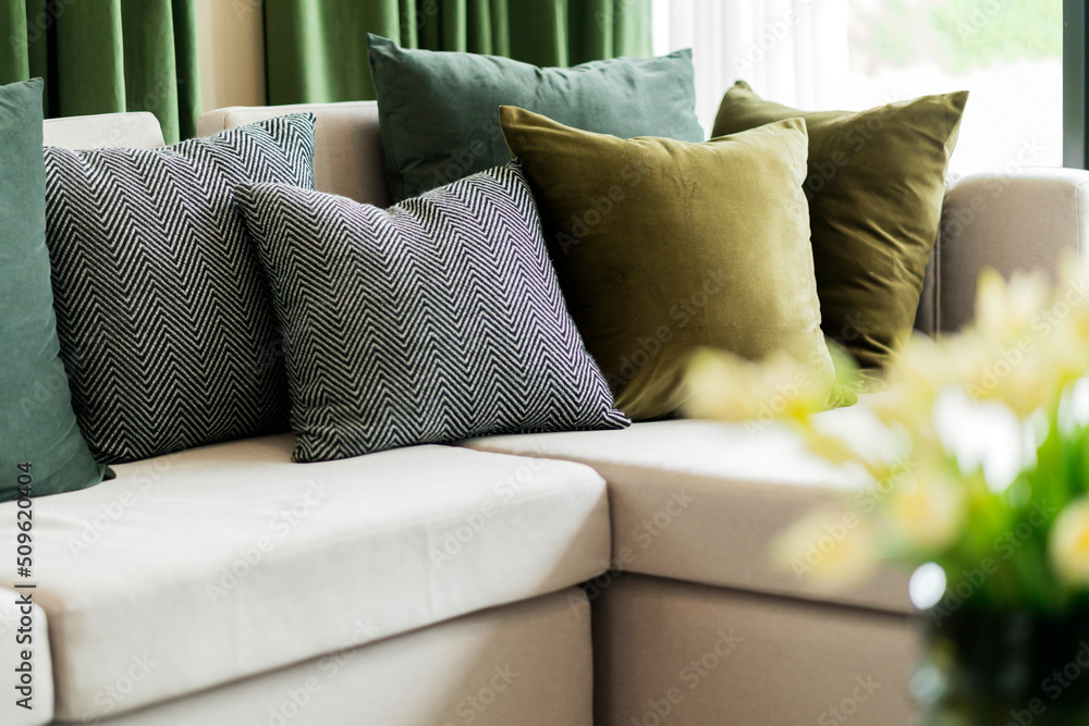 Close-up of beige earth tone pillow cushion set arrange on sofa couch in living room interior design