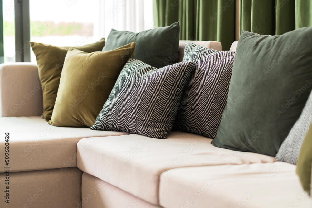 Close-up of beige earth tone pillow cushion set arrange on sofa couch in living room interior design