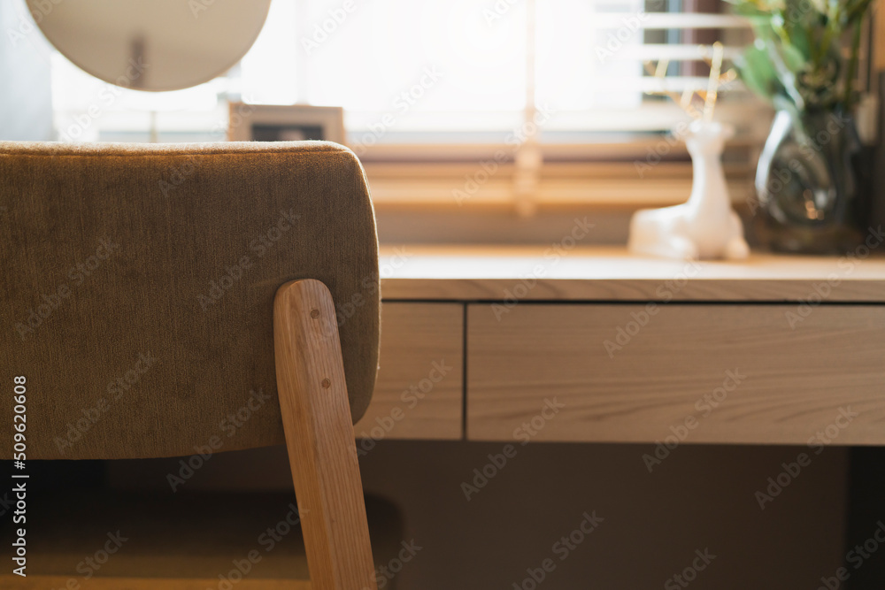 close up working chair with wooden table working top and blur background of wooden shutter blind win