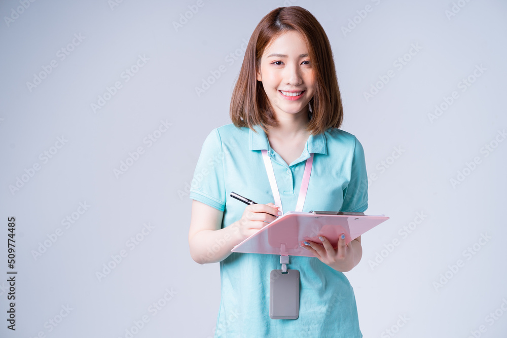 Portrait of young Asian businesswoman on white background