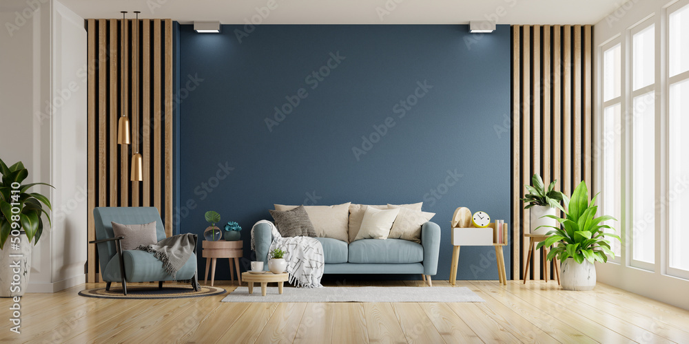 Interior of light room with sofa and armchair on empty dark blue wall background.