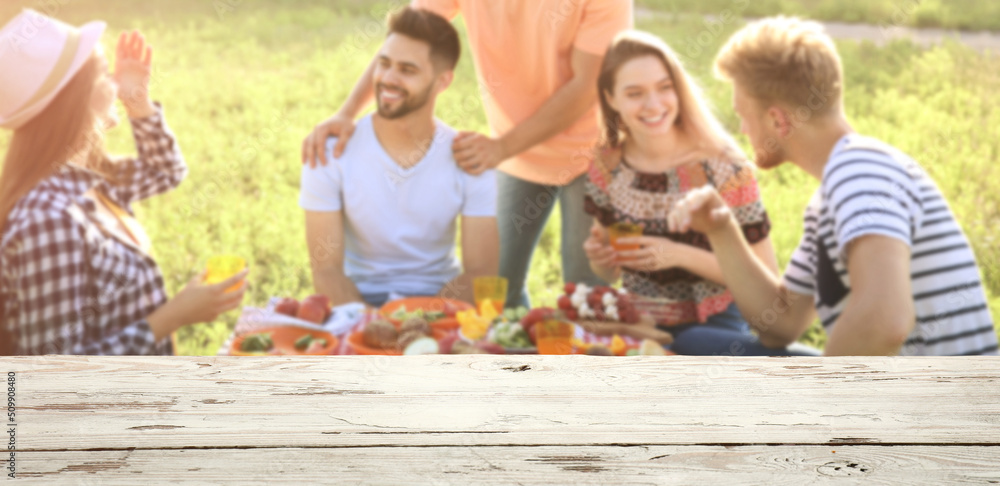 Empty wooden table at barbecue party outdoors