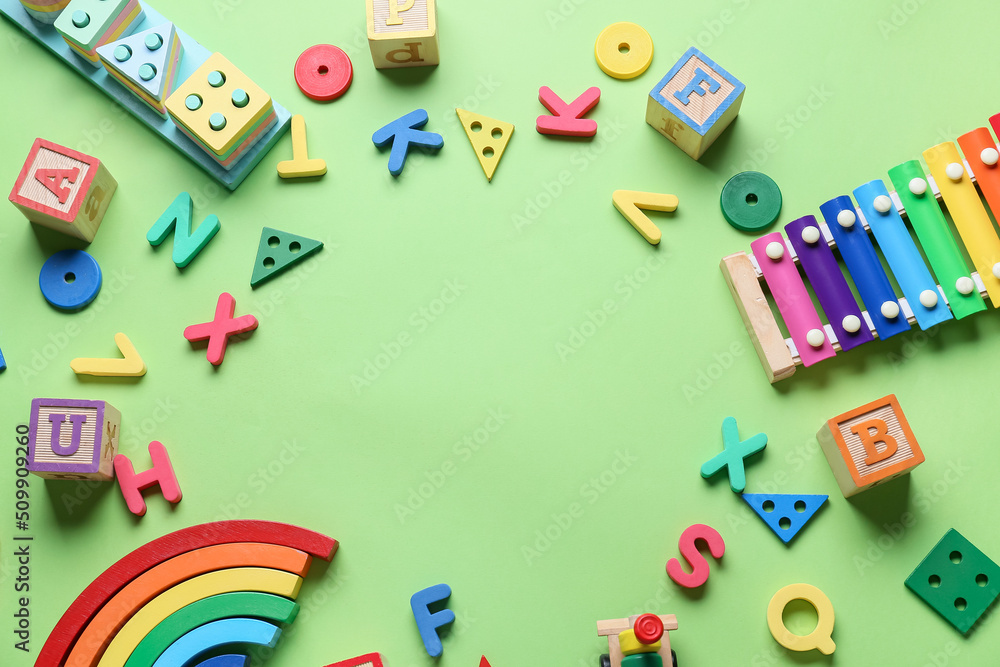 Frame made of educational toys on green background