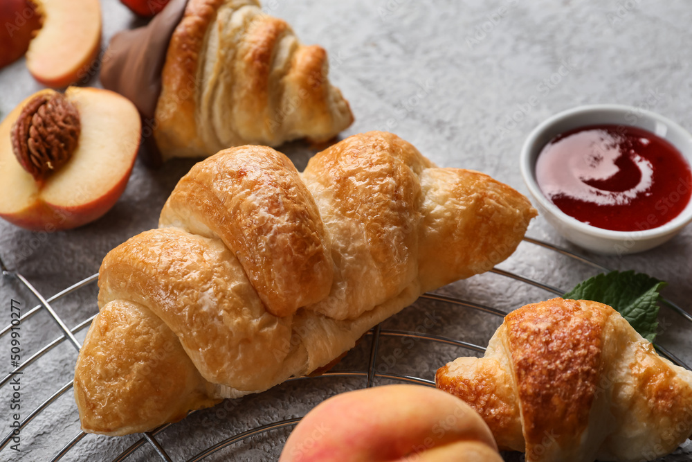 Grid of delicious croissants on light background, closeup