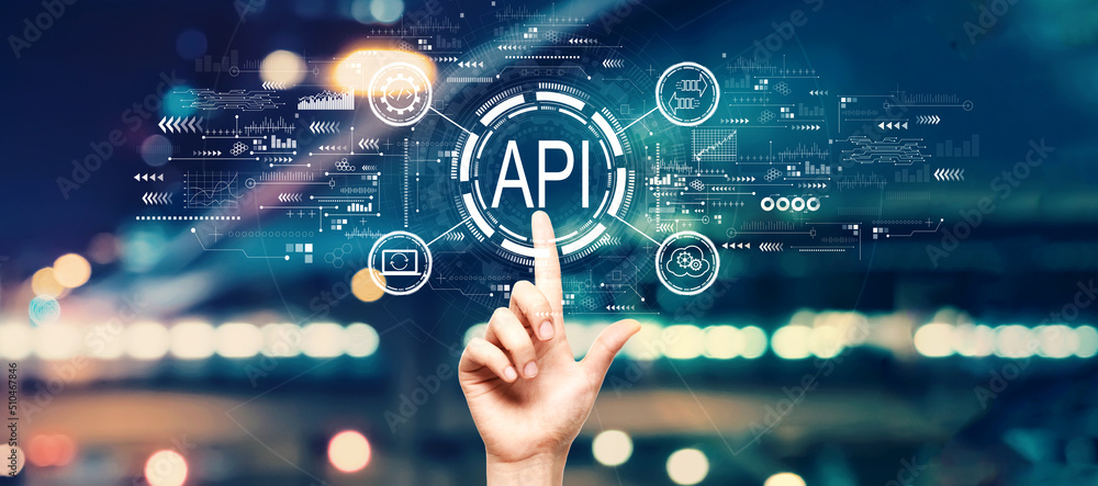 API - application programming interface concept with hand pressing a button on a technology screen