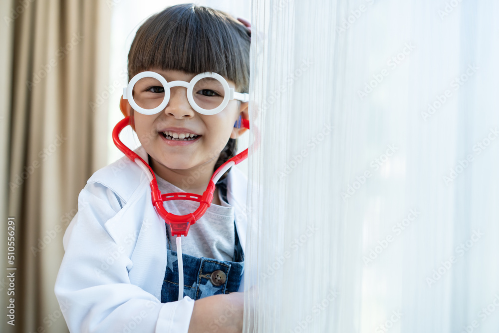 Portrait of Caucasian girl wear doctor uniform stand in living room. 