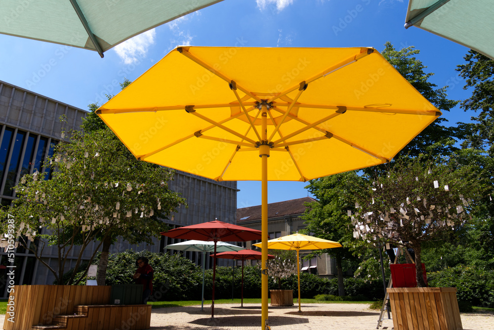 Close-up of yellow sunshade at park at City of Zürich on a blue cloudy spring day. Photo taken May 3